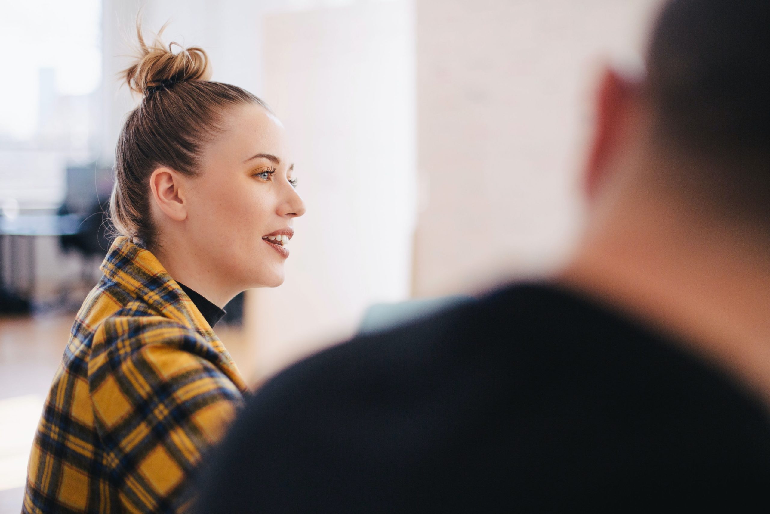 Female leader speaking to staff in meeting